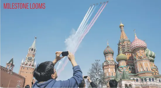  ?? Picture: AFP ?? Russian Su-25 fighter jets release smoke in the colours of the Russian flag while flying over Red Square during a rehearsal yesterday for the Victory Day military parade in Moscow. Russia celebrates the 73rd anniversar­y of the 1945 victory over Nazi...