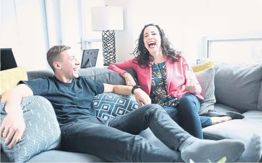  ?? RENÉ JOHNSTON/TORONTO STAR ?? Martin Greenaway and his step-mom, MaryLynne Meschino, an interior designer, relax on one of his key furnishing­s: a big sectional sofa.