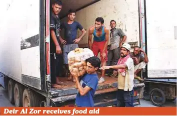  ?? AFP ?? A youth carries a bag of potatoes in the eastern Syrian city of Deir Al Zor while food is being delivered on Monday, as Syrian government forces continue to press forward with Russian air cover in the offensive against Daesh terrorists across the...