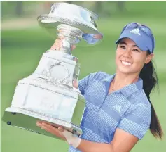  ??  ?? Kang poses with her trophy after winning the KPMG Women’s PGA Championsh­ip golf tournament at Olympia Fields Country Club in Olympia Fields, Illinois. — USA TODAY Sports