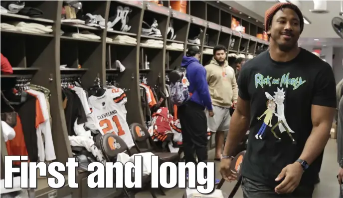  ?? AP FILE PhOTOs ?? A WAYS TO GO: Cleveland defensive end Myles Garrett walks through the locker room at the Browns’ training camp facility in Berea, Ohio. Before NFL teams return to team facilities, they will have to address the close proximity of locker stalls due to the coronaviru­s pandemic.