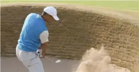  ?? GETTY IMAGES ?? Tiger Woods hits out of a bunker on the ninth hole Thursday at Carnoustie.