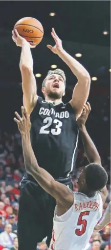  ?? Rick Scuteri, The Associated Press ?? Colorado forward Lucas Siewert tries to score against Arizona guard Brandon Randolph during the first half of their teams’ Pac12 game Thursday night in Tucson.