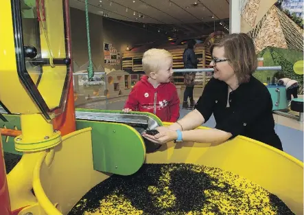  ?? PHOTOS: GREG SOUTHAM ?? Nancy Thomas, the early learning and child care chair at MacEwan University, plays with Hudson Heagle, 3, in the RAM’s Children’s Gallery. The space includes hands-on activities for kids of all ages — even infants.