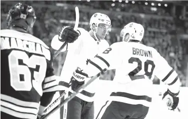  ?? Michael Dwyer/Associated Press ?? ■ Toronto Maple Leafs’ Connor Brown (28) celebrates his goal with teammate Auston Matthews as Boston Bruins’ Brad Marchand (63) looks on during the first period of Game 5 of an NHL hockey first-round playoff series Saturday in Boston. The Maple Leafs...