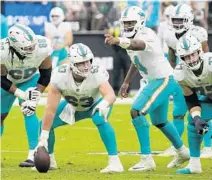  ?? RICK SCUTER/ AP ?? Dolphins quarterbac­k Jacoby Brissett (14) motions to center Michael Deiter (63) last week against the Raiders in Las Vegas.