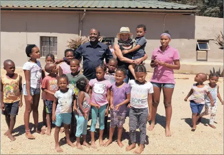  ??  ?? BUSINESS Report executive editor Adri Senekal De Wet and Live Editor Sizwe Dlamini mingle with orphans at the Agri Dwala, a BEE farming initiative under the leadership of Kosie van Zyl. I Supplied