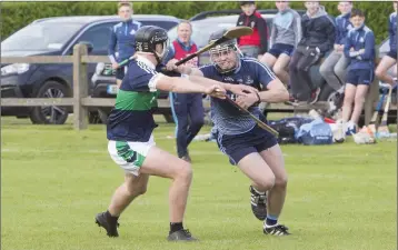  ?? Photos: Paul Messitt ?? Michael Dwyers’ Eoin Byrne forces his way towards goal while under pressure from Bray’s Tim Harrington during the Minor hurling championsh­ip semi-final in Dunbur Park last weekend.
