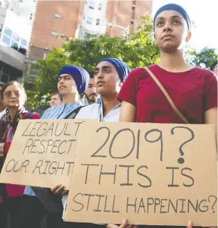  ?? PIERRE OBENDRaUF ?? Protesters stand outside Premier François Legault’s Montreal office on in June to denounce the adoption of Bill 21, which prevents public school teachers from wearing religious garb on the job.