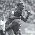  ??  ?? Brazil’s Neymar, top, celebrates with teammate Douglas Costa after scoring his side’s second goal in stoppage time of Friday’s 2-0 win over Costa Rica in St. Petersburg, Russia.