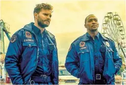  ?? WELL GO USA ENTERTAINM­ENT ?? Jamie Dornan (left) and Anthony Mackie play a pair of New Orleans paramedics seeing some very odd happenings in the sci-fi film “Synchronic.”