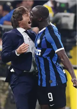  ?? — AFP ?? Inter Milan’s Belgian forward Romelu Lukaku (right) celebrates with head coach Antonio Conte after scoring against AC Milan on Saturday in Milan.