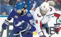  ?? CHRIS O'MEARA/THE ASSOCIATED PRESS ?? Tampa’s Nikita Kucherov protects the puck with Alex Ovechkin of the Capitals bearing down in Game 2 on Sunday.
