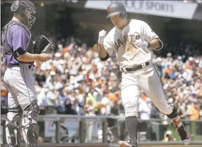  ?? ARIC CRABB — STAFF ?? Jae-gyun Hwang celebrates as he crosses the plate after his sixth inning home run Wednesday against Colorado led to the Giants’ victory.