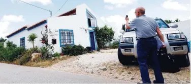  ?? Reuters ?? ↑
A reporter takes a picture of the house in Lagos, Portugal, where the suspect lived when Madeleine Mccann disappeare­d in 2007.