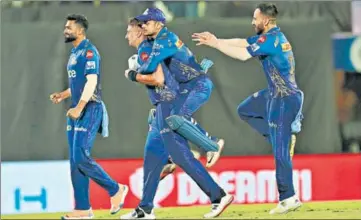  ?? BCCI ?? Mumbai Indians players celebrate their win over table toppers Gujarat Titans at the Brabourne stadium on Friday.