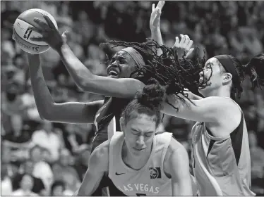  ?? SEAN D. ELLIOT/ THE DAY ?? Connecticu­t Sun center Jonquel Jones (left, with ball) is fouled by Las Vegas Aces forward Dearica Hamby (5) as JiSu Park, right, helps on defense in the first half of WNBA action Sunday at Mohegan Sun Arena.