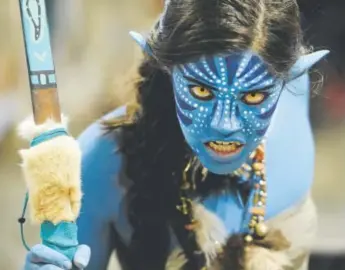  ??  ?? Brittany Ching, dressed as a character from “Avatar,” wields a bow at the 2016 Denver Comic Con at the Colorado Convention Center. Attendees will face new policies on cosplay props in 2017 — including a ban on any realistic-looking or functional...