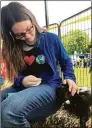  ?? Deborah Rose / Hearst Connecticu­t Media file photo ?? Above, Emily O’Donnell of New Jersey, niece of Trish Weller of New Milford, gets up close and personal with the baby goats at the Goatboy Soaps tent.