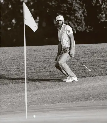  ?? Doug Mills / New York Times ?? Dustin Johnson reacts to a missed birdie putt on No. 18 during the third round of the Masters. Johnson settled for a par, part of his bogey-free 65, and heads into today’s final round with a four-shot lead.