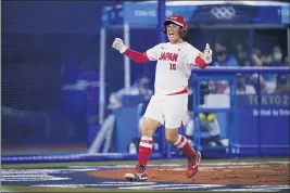  ?? SUE OGROCKI — THE ASSOCIATED PRESS ?? Japan’s Yamato Fujita celebrates scoring during the fourth inning of a softball game against the United States at the 2020Summer Olympics in Yokohama, Japan.