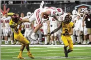  ?? L.E. BASKOW/AP ?? With teammate Deandre Pierce looking on, Arizona State defensive back Kejuan Markham (12) tries to bring down Wisconsin tight end Jake Ferguson on Thursday.