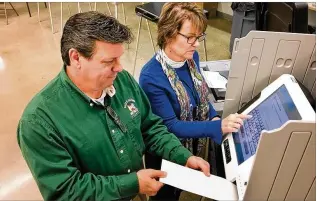  ?? CHRIS STEWART / STAFF ?? Montgomery County Board of Elections Director Jan Kelly and Deputy Director Steve Harsman give a presentati­on to county commission­ers on the touch screen hybrid voting system the elections board members recommend.