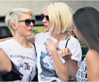  ??  ?? Theresa May, left, Sadiq Khan and Sajid Javid were among the VIPS with floral tributes. Above left, PC Wayne Marques, 39, who fought the terrorists. Above, friends of James Mcmullan, the only British fatality of the attacks