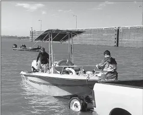  ?? Arkansas Democrat-Gazette/BRYAN HENDRICKS ?? A trio of cat fishermen prepare to brave high wind and heavy current on the Arkansas River Thursday at David D. Terry Lock and Dam.