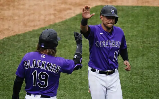  ?? Ross D. Franklin, The Associated Press ?? Colorado’s Jose Iglesias, right, celebrates scoring a run against the Texas Rangers with Charlie Blackmon during a spring training game last month in Scottsdale, Ariz.