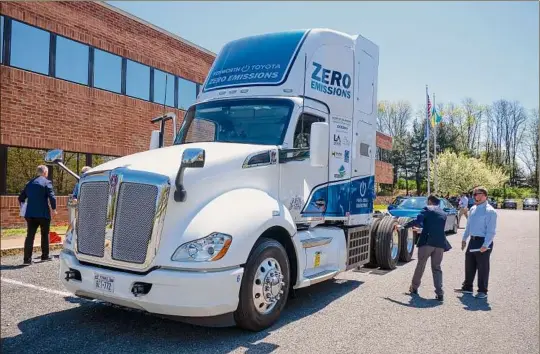  ?? Photos by Paul Buckowski / Times Union ?? People gather Tuesday to look over a hydrogen-powered semi-tractor truck produced through a partnershi­p with Toyota and Kenworth.