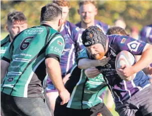  ?? Pic:RICHARD BIRCH ?? Menai Bridge’s Chris Roberts powers his way through these Bangor tackles during the sides’ clash last weekend