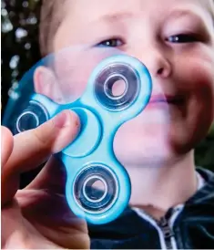 ??  ?? A fidget spinner: Toy that’s taken playground­s by storm
