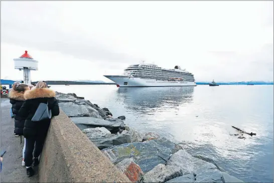  ?? [SVEIN OVE EKORNESVAG/NTB] ?? The cruise ship Viking Sky arrives at the port of Molde, Norway, using three of its four engines Sunday. The owner, Viking Ocean Cruises, said 479 passengers had been airlifted to land earlier after a mayday call Saturday, leaving 436 passengers and 458 crew members onboard. Twenty people were injured.