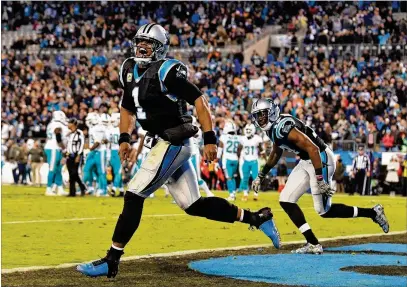  ?? GRANT HALVERSON / GETTY IMAGES ?? Cam Newton (left) and Devin Funchess celebrate one of Funchess’ two touchdowns during the second half of Carolina’s Monday night victory. Newton threw for 254 yards and four touchdowns and rushed for 95 yards.