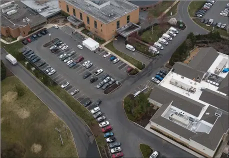  ?? RICH HUNDLEY III - FOR THE TRENTONIAN ?? A drone view of the parking lot at Robert Wood Johnson in Hamilton where a tent officials set up a triage tent for new patients to contain the spread of coronaviru­s.