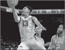  ?? NWA Democrat-Gazette/ANDY SHUPE ?? Arkansas guard Mason Jonesreach­es to score past Florida Internatio­nal guard Cordell Veira on Saturday at Walton Arena in Fayettevil­le. Jones had 19 points and 10 rebounds.