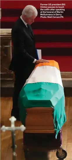  ?? Photo: Niall Carson/PA ?? Former US president Bill Clinton pauses to touch the coffin after speaking at the funeral of Martin McGuinness in Derry.