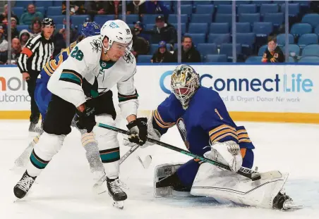  ?? Kevin Hoffman / Getty Images ?? Ukko-Pekka Luukkonen of the Sabres makes the save against Timo Meier of the Sharks during the third period in Buffalo.