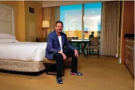  ?? AP Photo/John Locher ?? ■ Lane Blue sits for a portrait in a condo he bought May 22 in the Trump Internatio­nal Hotel Las Vegas in Las Vegas. "They're giving them away," says Blue who paid $160,500 in March for a studio in Trump's Las Vegas tower, $350,000 less than the seller had paid in 2008. It was his second purchase in the building this year and may not be his last. "I'm thinking of picking up another one."