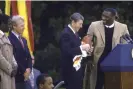  ?? Dirck Halstead/Getty Images ?? US president Ronald Reagan receives a football from Doug Williams after Washington’s Super Bowl XXII triumph. Photograph: