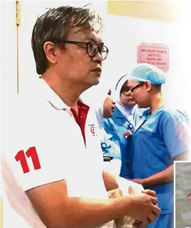 ??  ?? Anxious moment: Evelyn Ang’s husband Dennis Loo waiting for news of his wife’s condition outside the intensive care unit of Sungai Buloh Hospital.