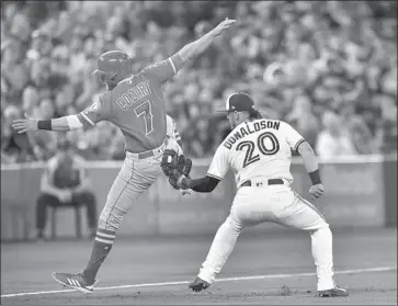  ?? Frank Gunn Associated Press ?? ZACK COZART of the Angels is tagged out at third base by Toronto’s Josh Donaldson to end the sixth inning.