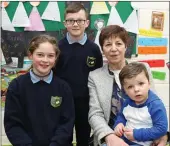  ??  ?? Stasia Sheahan with her grandchild­ren Chloe, Liam Óg and Lewis at Meelin National School.