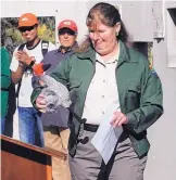  ?? JIM THOMPSON/JOURNAL ?? Christy Tafoya, director of New Mexico State Parks, considers a toy sandhill crane that was on the podium as she spoke at the recent 35th anniversar­y celebratio­n for the Rio Grande Nature Center State Park.