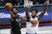  ?? FRANK FRANKLIN II — THE ASSOCIATED PRESS ?? The Brooklyn Nets’ Kyrie Irving (11) drives past the New York Knicks’ Julius Randle (30) during the first half on Monday in New York.