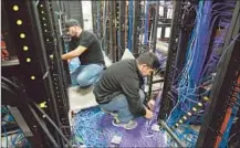  ??  ?? TECHNICIAN­S install cables at the studio and broadcast center on Pico Boulevard. KWHY Channel 22 staffers will work there.