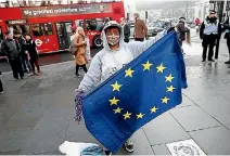  ?? PHOTO: REUTERS ?? A man holds a European Union flag outside the Supreme Court in Parliament Square, central London.