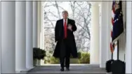  ?? AP PHOTO/JACQUELYN MARTIN ?? President Donald Trump waves Friday as he walks through the Colonnade from the Oval Office of the White House on arrival to announce a deal to temporaril­y reopen the government in Washington.