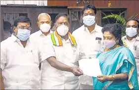  ?? PTI ?? Puducherry chief minister V Narayanasa­my hands over his resignatio­n to Lt Governor Tamilisai Soundarara­jan after he failed to prove his majority in the assembly, in Puducherry on Monday.